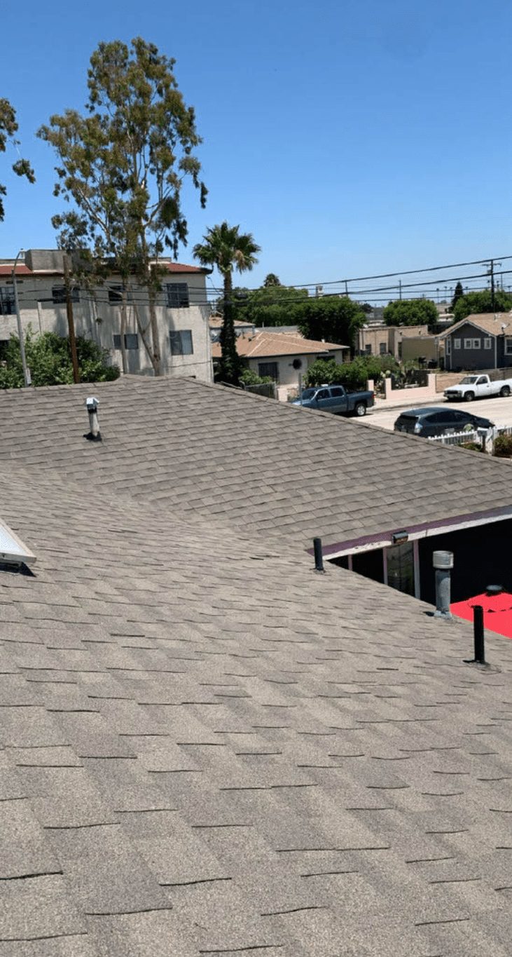 Older residential roof and neighboring homes in Ventura County, the kind of pre-1978 housing that requires lead-based paint assessment.